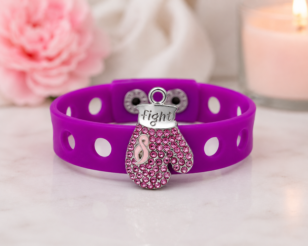 💖 Bold awareness bracelet featuring a sparkling pink rhinestone boxing glove charm and vibrant adjustable silicone band. Stylish, inspiring, and made to empower.