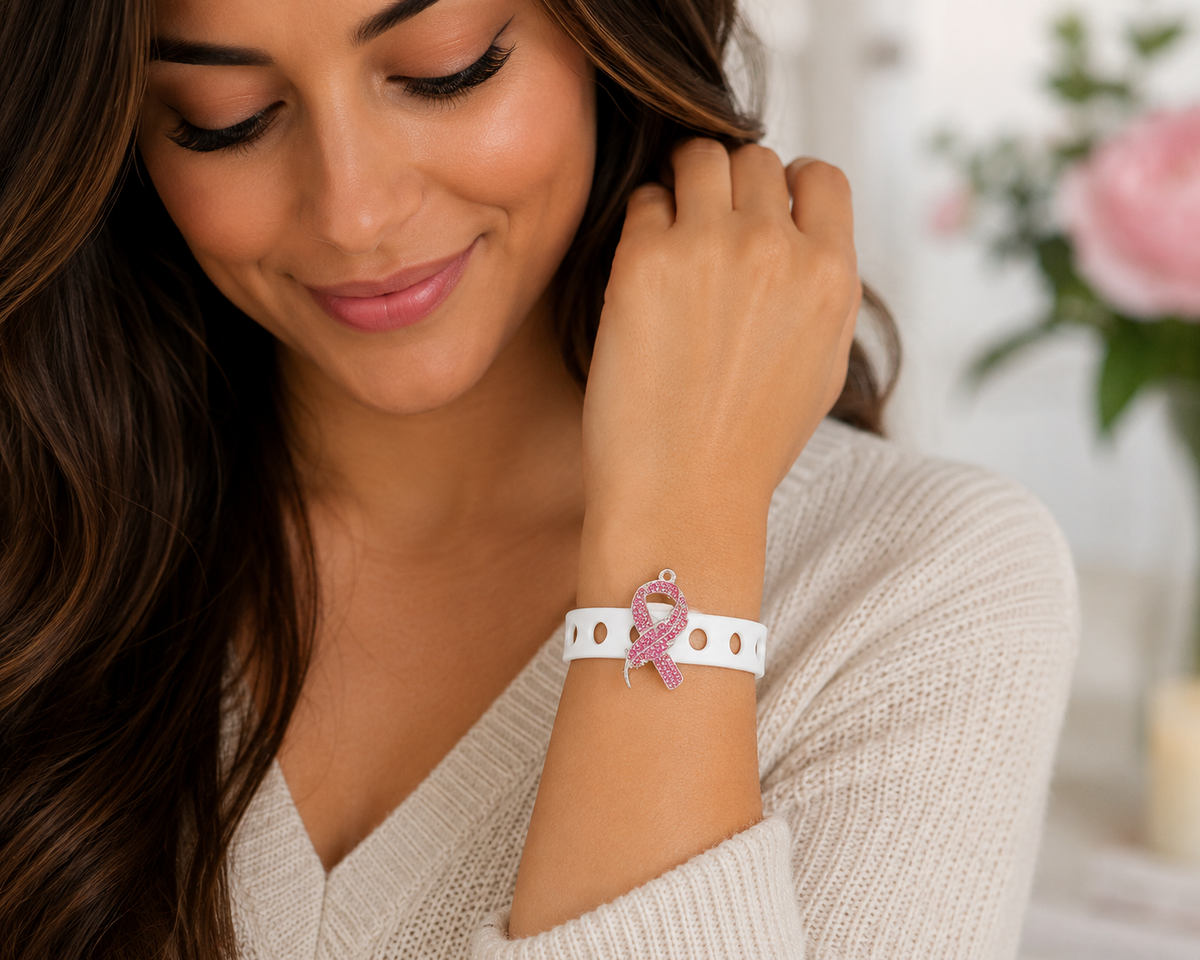 💖 Elegant pink awareness bracelet featuring a sparkling rhinestone ribbon charm and adjustable white silicone band. Stylish, inspiring, and perfect for everyday wear.