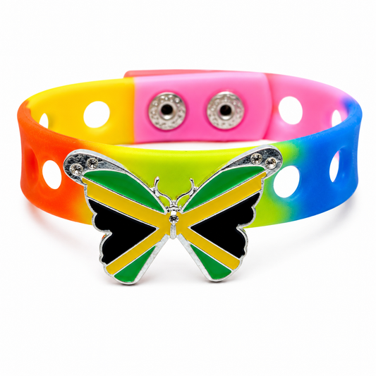 Show your Jamaican pride with the Jamaica in Flight Bracelet. Features a butterfly charm inspired by the Jamaican flag, a colorful adjustable band, and secure snap-lock closure.