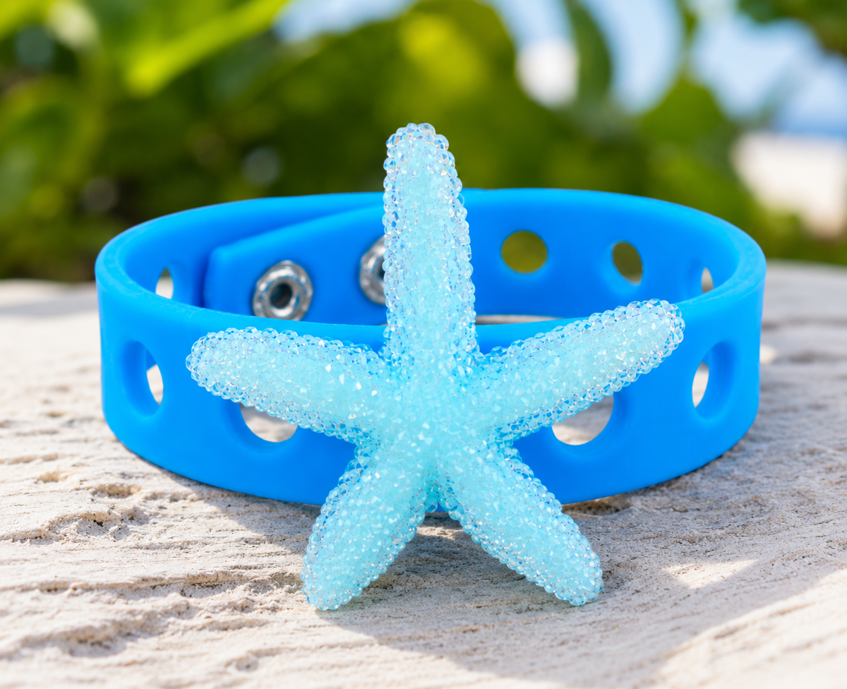 Ocean-inspired bracelet featuring a sparkling starfish centerpiece and vibrant blue silicone band. Perfect for beach lovers, vacations, and coastal style.